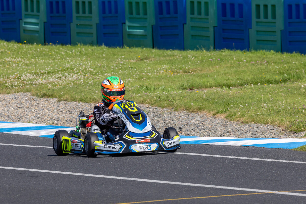 Oliver Meredith on track wearing his green, white and orange helmet